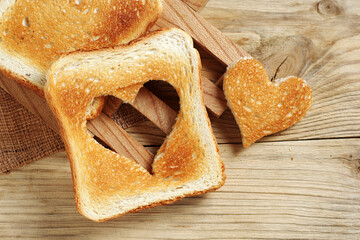 Wall Mural - Toasted bread with cut out heart-shaped slice