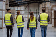 © Halfpoint - Rear view of warehouse workers walking in warehouse. Team of warehouse workers preparing products for shipment.