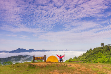 Wall Mural - Man tourist with his orange tent in Mae Moei Nationnal Park border of Thailand and Myan Mar, Tak province Thailand.