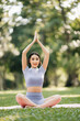 © Nuttapong punna - Portrait of young woman practicing yoga in garden.female happiness.  in the park blurred background.