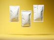 Three white ziplock bags floating in the air on a yellow background. Packaging mockup for tea, coffee, dried fruits or nuts.