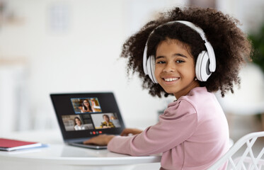 Poster - Cute little african american girl attending online lesson from home