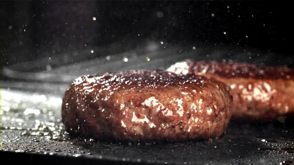 Sticker - A beef burger falls into a hot pan with a splash of oil. Filmed on a high-speed camera at 1000 fps. High quality FullHD footage