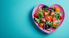 Salad Greens Mix In Pink Heart Shape Plate On Blue Background, Health Concept, Copy Space
