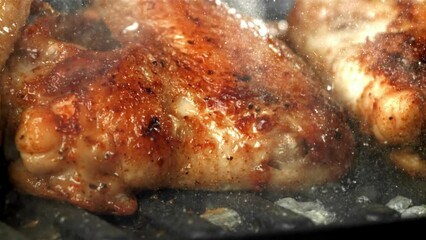 Canvas Print - Chicken wings are fried in a pan. Filmed on a high-speed camera at 1000 fps. High quality FullHD footage