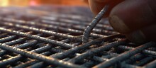 Close-up Of The Hands Of A Worker Installing A Metal Fence