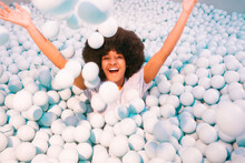 Playful Young Woman Playing In Ball Pool