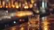 A glass drink of whiskey on the bar table blur background. AI generated image