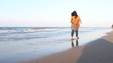 Woman In Gamis Shirt Close Up Walking On Wet Sand And Ocean Waves Lightly Touching Feet Enjoying Winter Trip To Tropical Resort With Deserted Beach. Vacation, Travel, Concept 