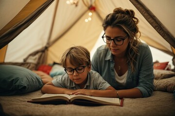 mother wearing glasses with her hair tied back reading a book