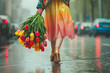 Portrait of a girl in a skirt and in heels with a bouquet of tulips from the back against the backdrop of a rainy city landscape. The concept of the arrival of spring and International Women's Day