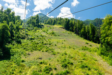 Cable Car Seats Soar Over Beautiful Mountains On A Sunny Day In Krasnaya Polyana