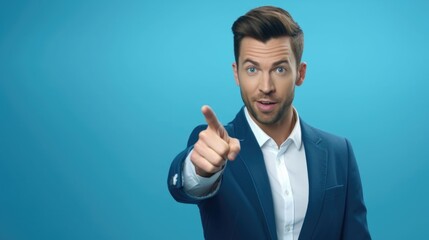 Poster - A man in a blue suit is pointing directly at the camera. This image can be used to convey confidence, authority, or as a representation of communication and engagement.