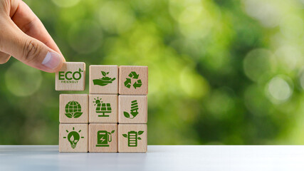 Wall Mural - ECO circular economy concept, recycling, environment, reuse, production, waste, consumer, resources, life cycle assessment, LCA, sustainability. Hand holding a wooden block with green icon. copy space