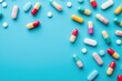 Top view colorful antibiotic capsule pills on blue background. Online pharmacy banner. World Health Day. Pharmaceutical industry. Prescription drugs