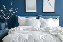Blue bed with white pillows duvet and duvet case Blue sofa with white bed linen Bedroom with bed and bedding and poster frame mock up on wall Left side view