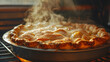 A rustic homemade apple pie fresh out of the oven with a golden crust and steam rising.