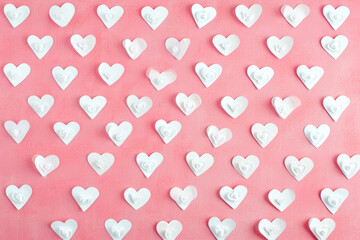 Wall Mural - pattern of white hearts on a pink background with a border of small hearts