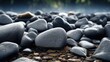 A collection of rocks sitting on top of a flowing river. Can be used to depict nature, landscapes, or the concept of stability