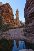 Tranquil Oasis Within Towering Sandstone Cliffs