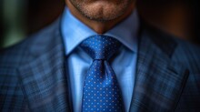  A Close Up Of A Man Wearing A Blue Suit With A Blue And Orange Polka Dot Tie And A Blue Dress Shirt With A Blue Blazer And Blue Shirt.