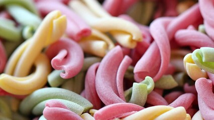 Aufkleber - Dry colored pasta in different colors.