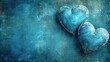  two heart shaped breads sitting on top of a blue counter top next to a blue and rusted metal wall with a rusted metal grunge finish.