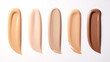 Different shades of liquid skin foundation on white background, top view.