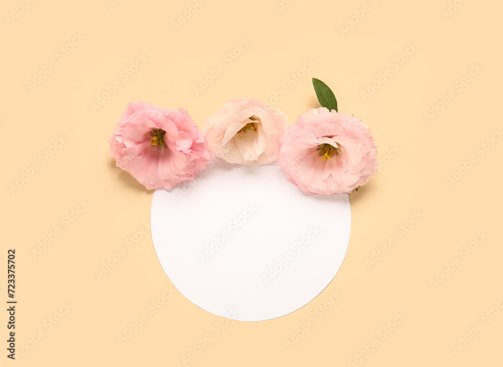 Composition with blank paper sheet and beautiful eustoma flowers on beige background