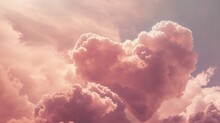 Beautiful Fluffy Clouds The Shape Of A Love Heart. Romantic Valentine’s Day Background With Pink Sky.