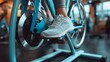 Fitness machine at home woman biking on indoor cycling stationary bike exercise indoors for cardio workout. Closeup of shoes on bicycle 