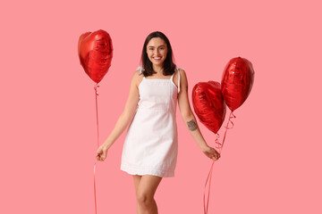 Poster - Beautiful young woman with air balloons in shape of heart on pink background. Valentine's Day celebration