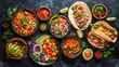 An assortment of dishes from Mexican cuisine presented against a dark background. 