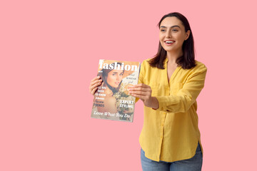 Poster - Beautiful woman with fashion magazine on pink background