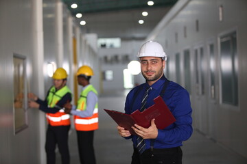 Wall Mural - worker or engineer working in factory with safety uniform , safety hat and safety glasses , image is safety concept or happy workplace