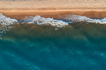 Poster - Relaxing aerial beach scene, summer vacation holiday template banner. Waves surf with amazing blue ocean lagoon, sea shore, coastline. Perfect aerial drone top view.