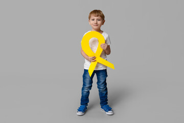 Sticker - Cute little boy with yellow ribbon on grey background. International Childhood Cancer Day