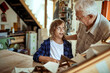 © Marko Geber - Grandfather and grandson working on a arts and crafts project in the garage