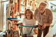 © Marko Geber - Grandfather and grandson working on a bicycle in the garage