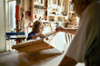 © Marko Geber - Grandfather and grandson working on a arts and crafts project in the garage