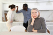 © JackF - Elderly upset woman sitting in kitchen during family quarrel between man and woman couple