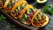 mexican street tacos flat lay composition with pork carnitas, avocado, onion, cilantro