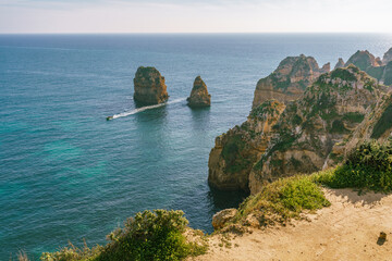 Wall Mural - Coastal path along the cliff tops provides stunning views of hidden coves, beaches, and rock formations. Lagos, Portugal