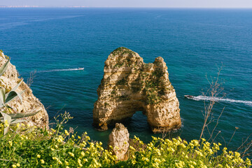 Wall Mural - Algarve, Portugal. Rocky coastline un a bright sunny day