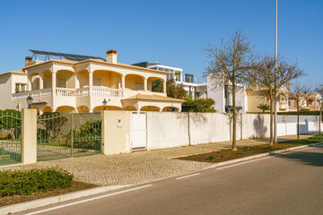 Wall Mural - Row of condos lining the street, blue sky in the background