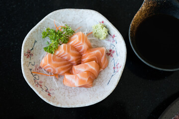 Wall Mural - Fresh salmon sashimi fish fillet on dish served with fresh wasabi. Top view