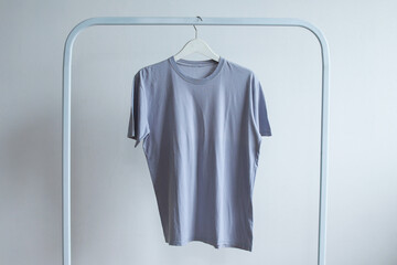 Wall Mural - Plain grey round neck t-shirt mockup hanging on clothes rack 