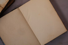 Close Top Down View Of An Open Blank Yellow Pages Of An Antique Vintage Book On Light Purple Background