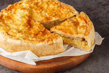 Canvas Print - Fruit and vegetable Swiss cholera pie with apple, potato, pear, onion and cheese close-up on a wooden board on the table. Horizontal