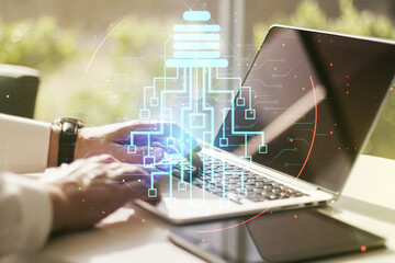 Poster - Double exposure of creative light bulb hologram with chip and hands typing on laptop on background, idea and brainstorming concept